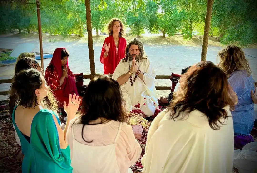 A group of people sitting in a circle during what appears to be a spiritual or meditation gathering.