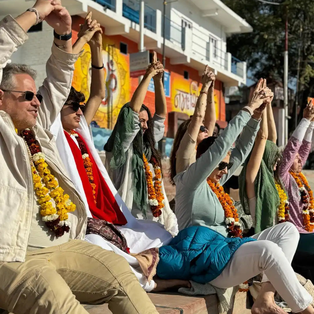 A group of people holding hands and leaning backwards while seated in a row.