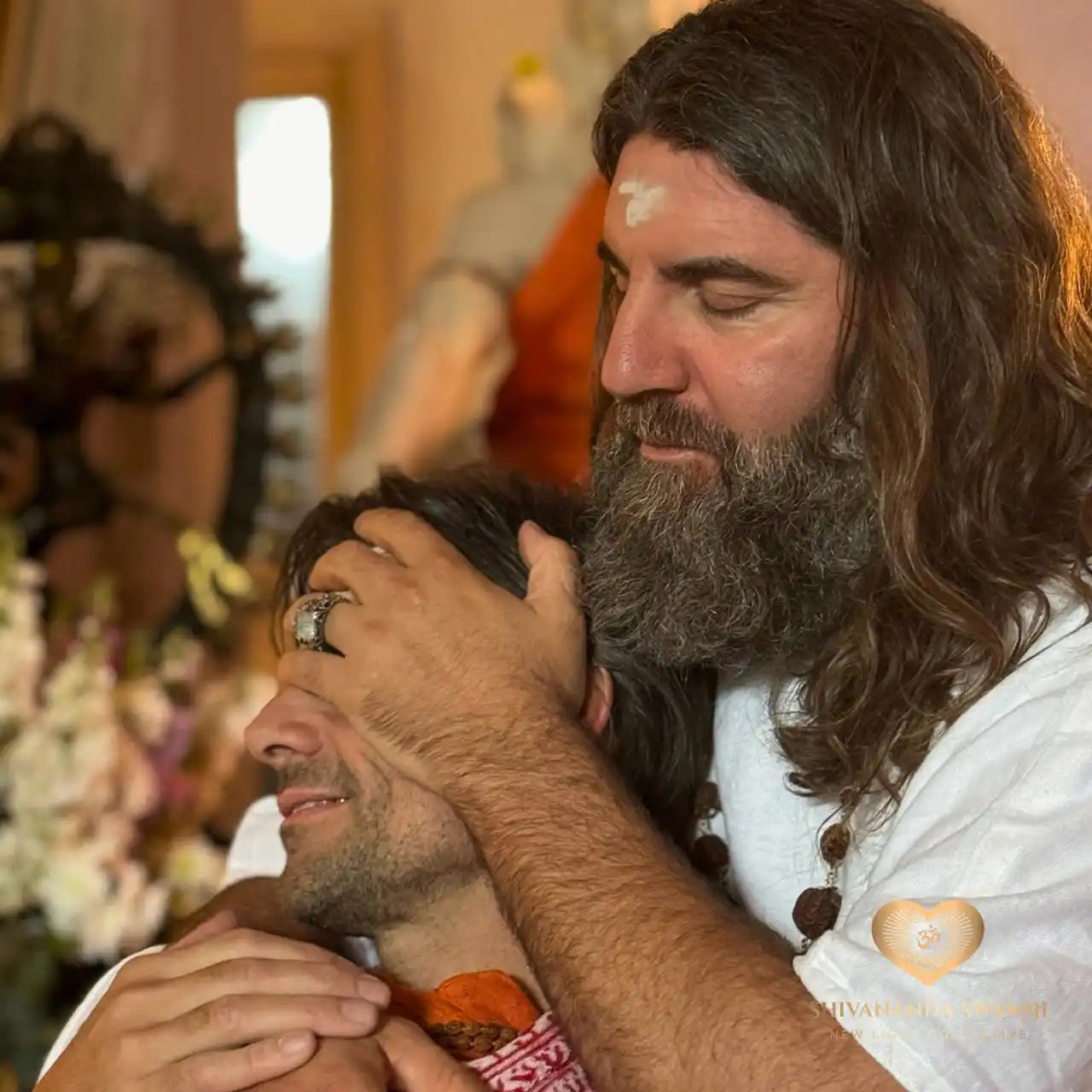 A man with long hair and a beard comforting another man.