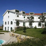 White building with a pool.