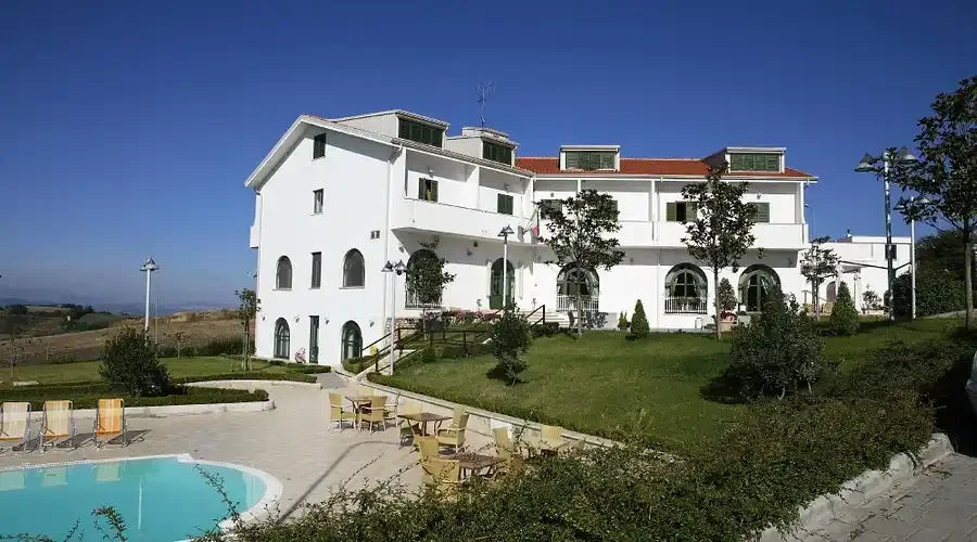 White building with a pool.