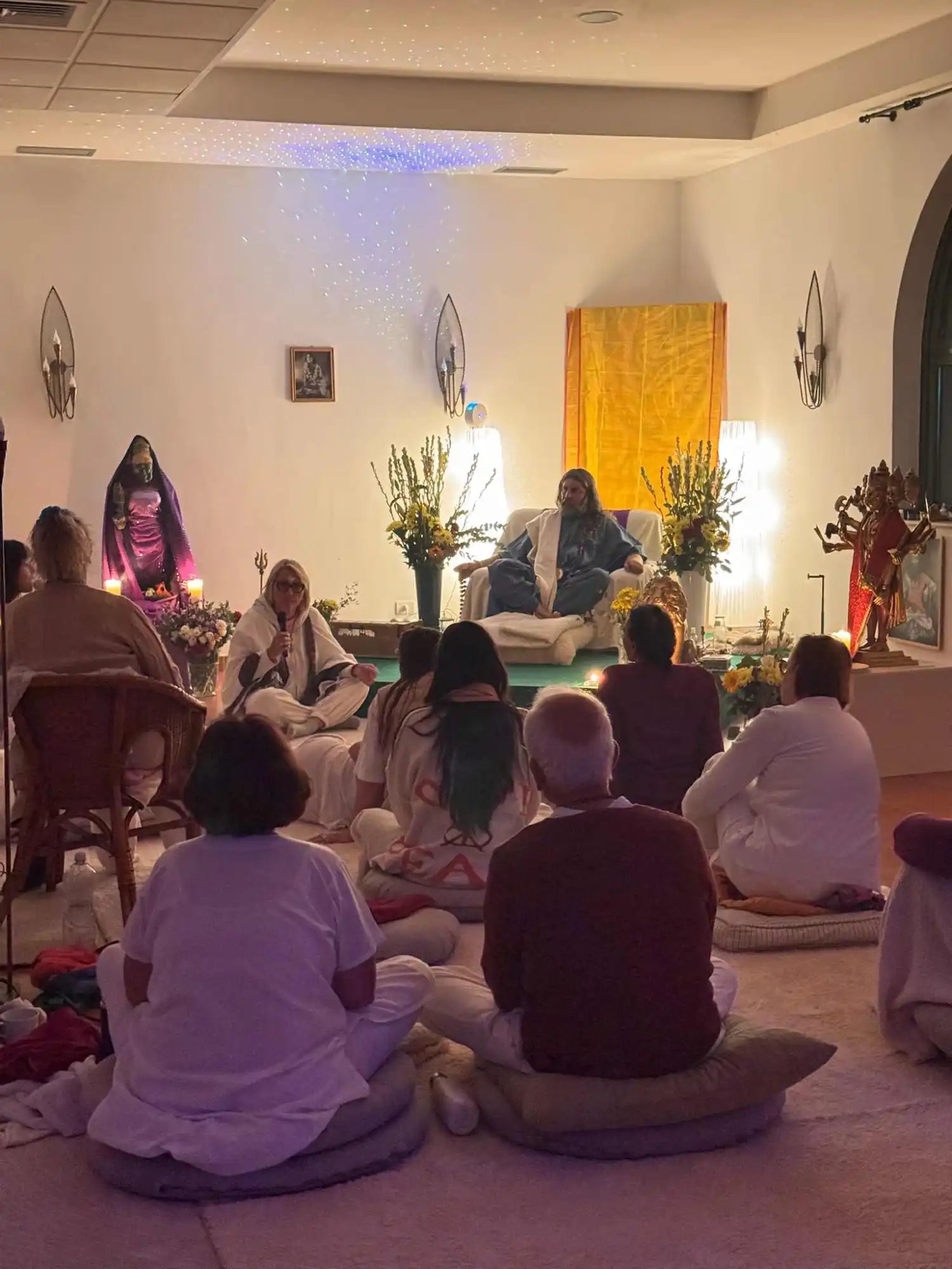 A group of people attending a spiritual gathering or meditation session.