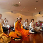 Group meditating indoors.