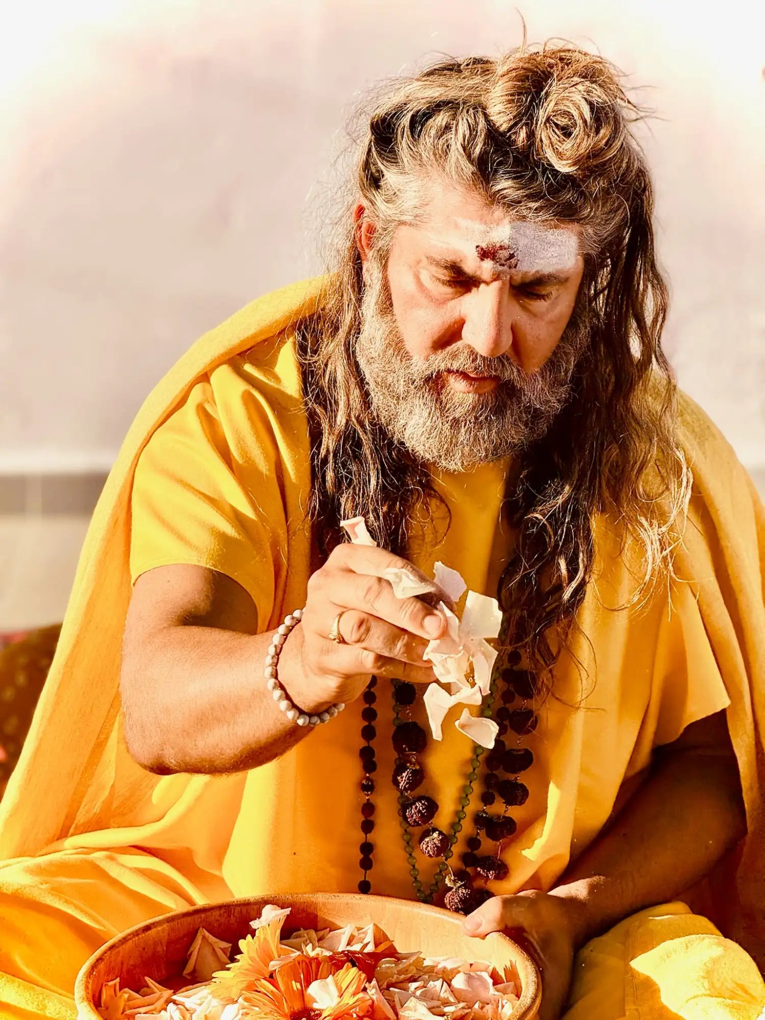 Yellow robe with floral design and beaded necklace